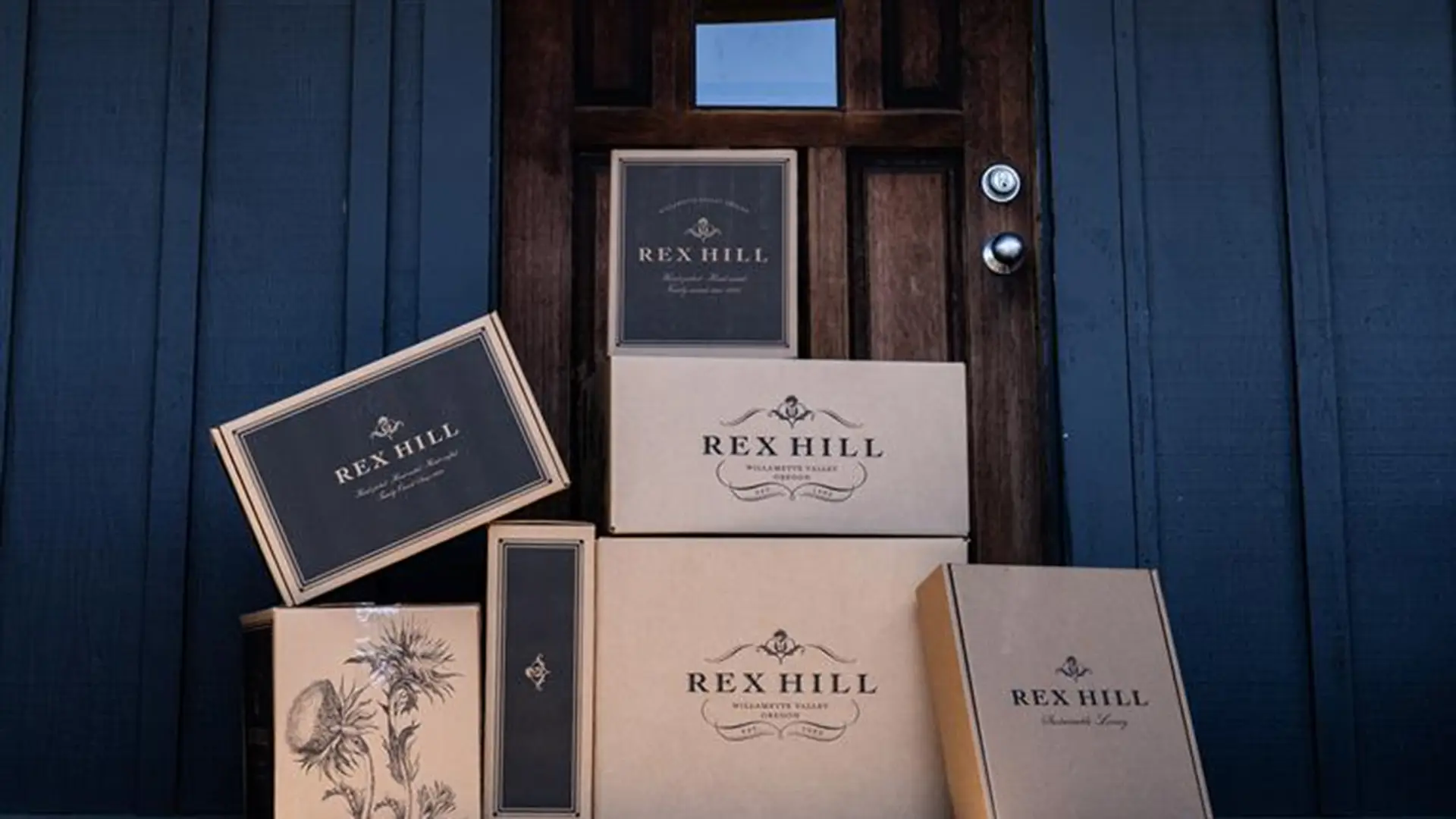 A front door with Rex Hill wine packages piled up outside.