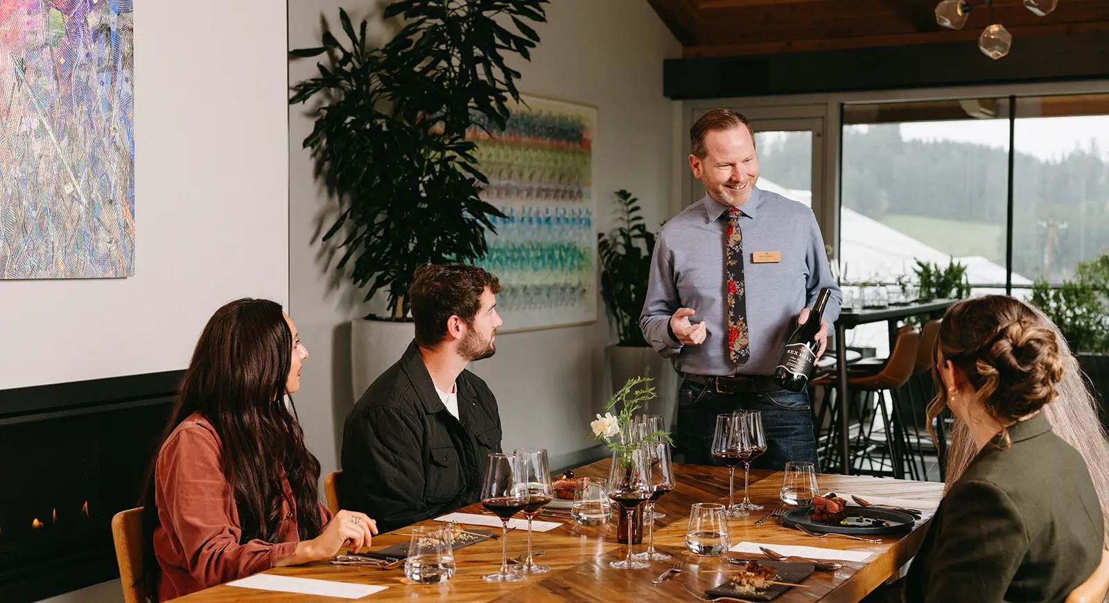 Rex Hill Team Member hosting visitors in the tasting room.
