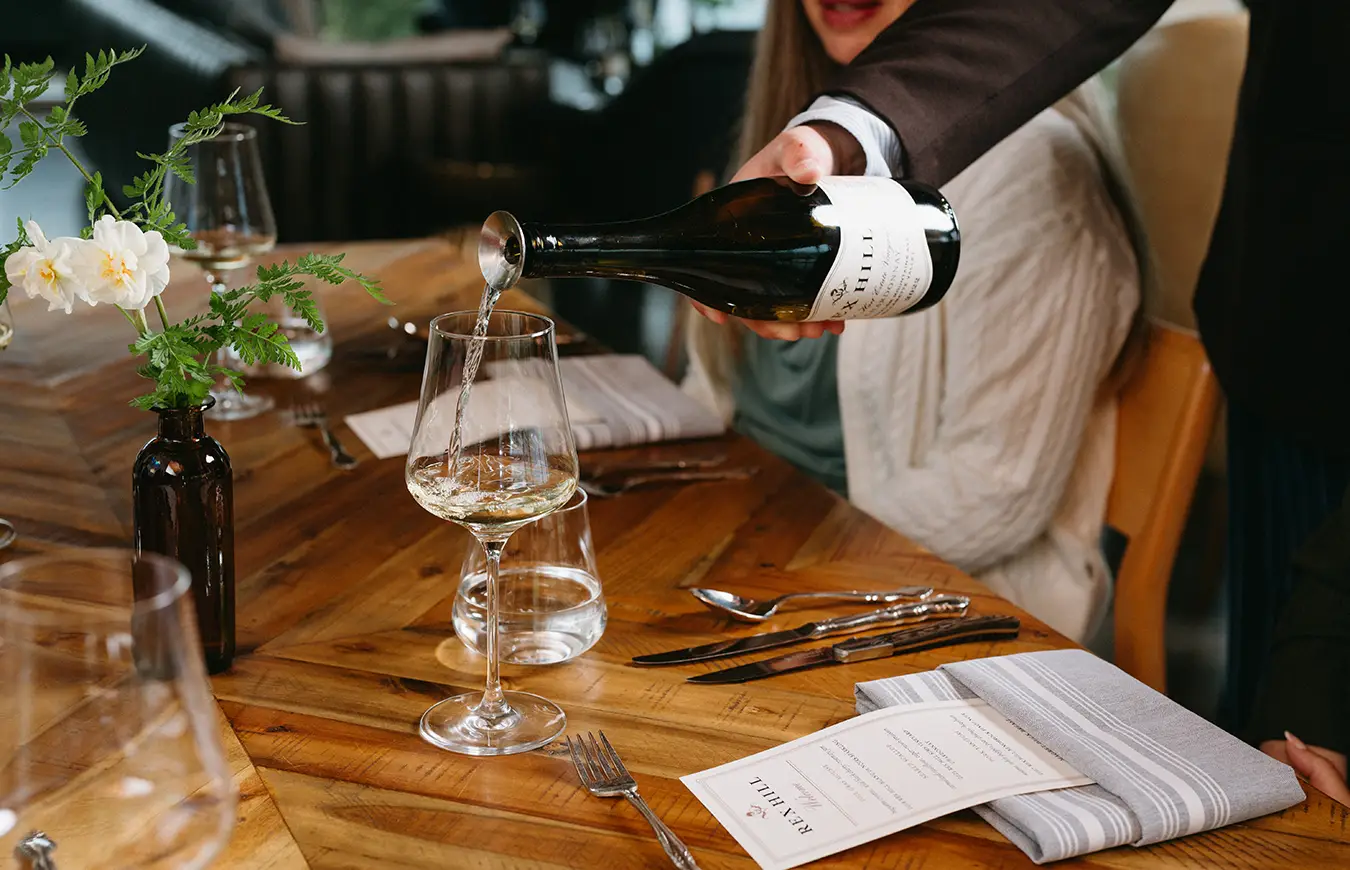 Wine being poured at the Rex Hill tasting room.