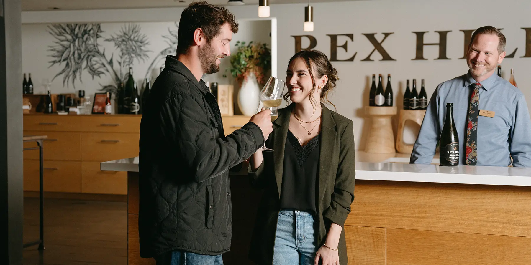 A couple enjoying wine at the Rex Hill Tasting Room.