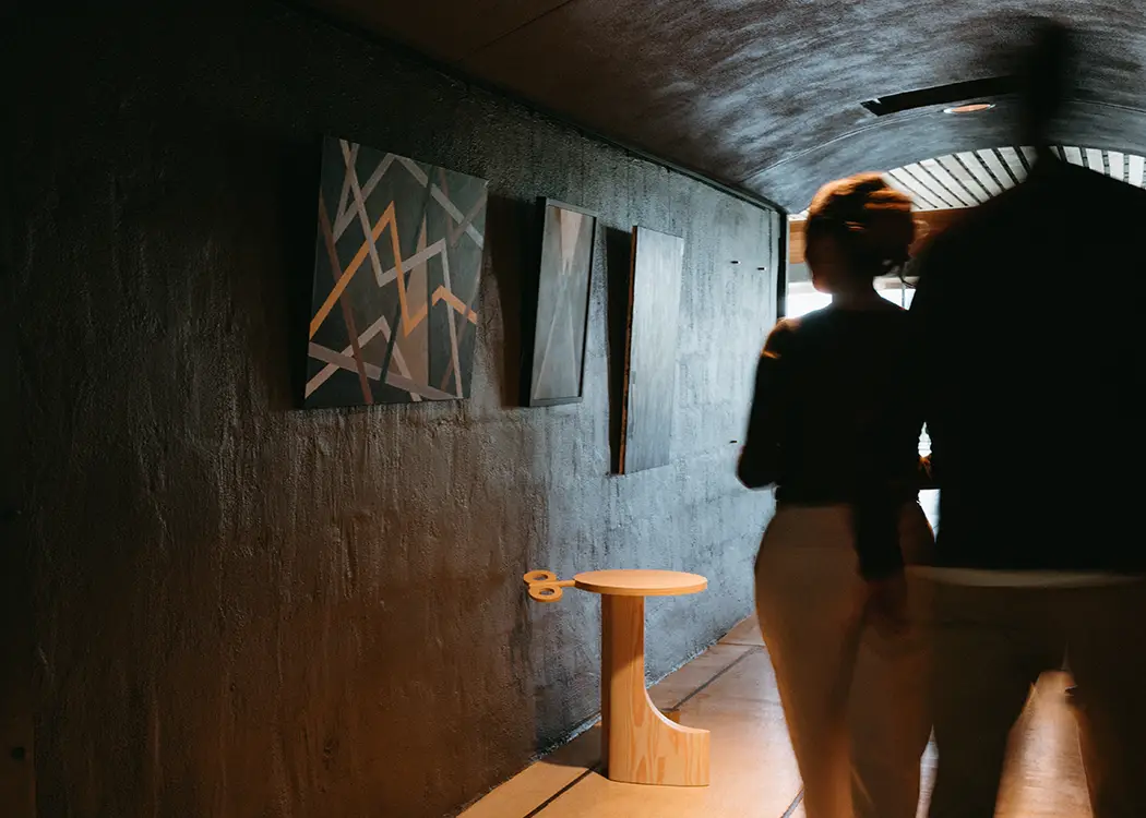 A couple viewing artwork in Rex Hill historic tunnels.