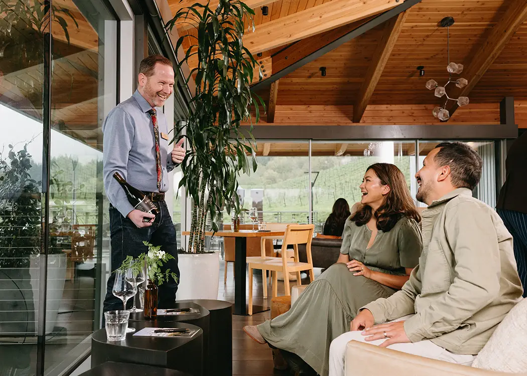 People enjoy wine in Rex Hill Tasting room.