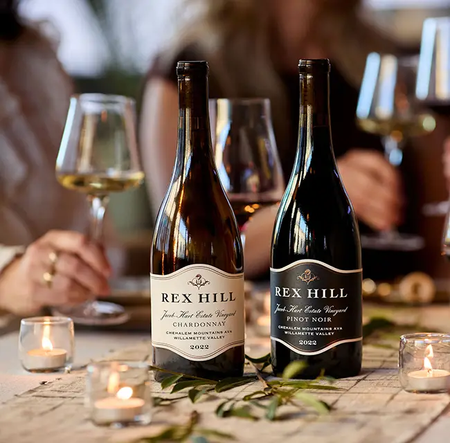 People enjoying Rex Hill wines by candle light.