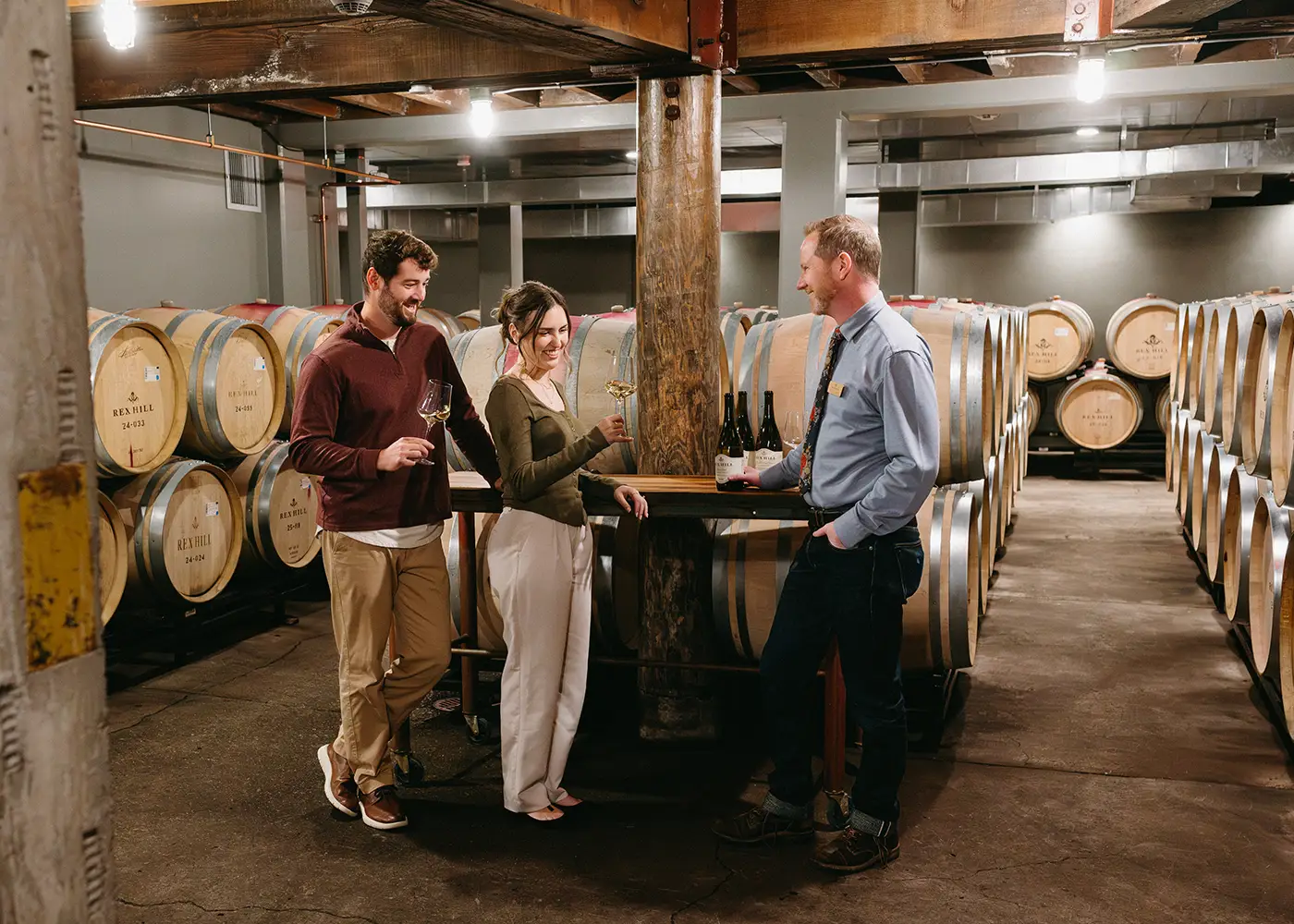 Man and women enjoying the Legacy Tour at Rex Hill Vineyards.