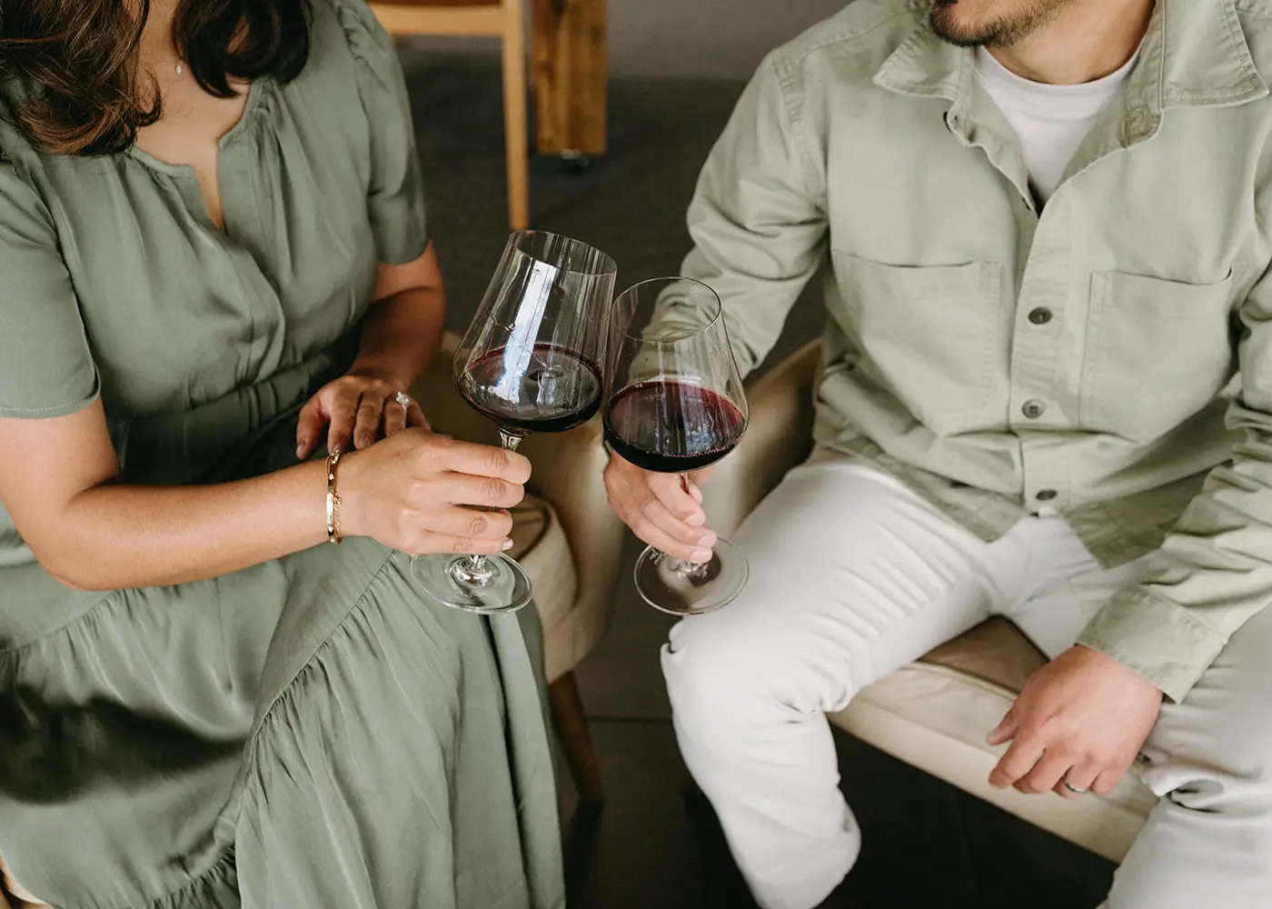Close up of a couple toasting with red wine at Rex Hill.